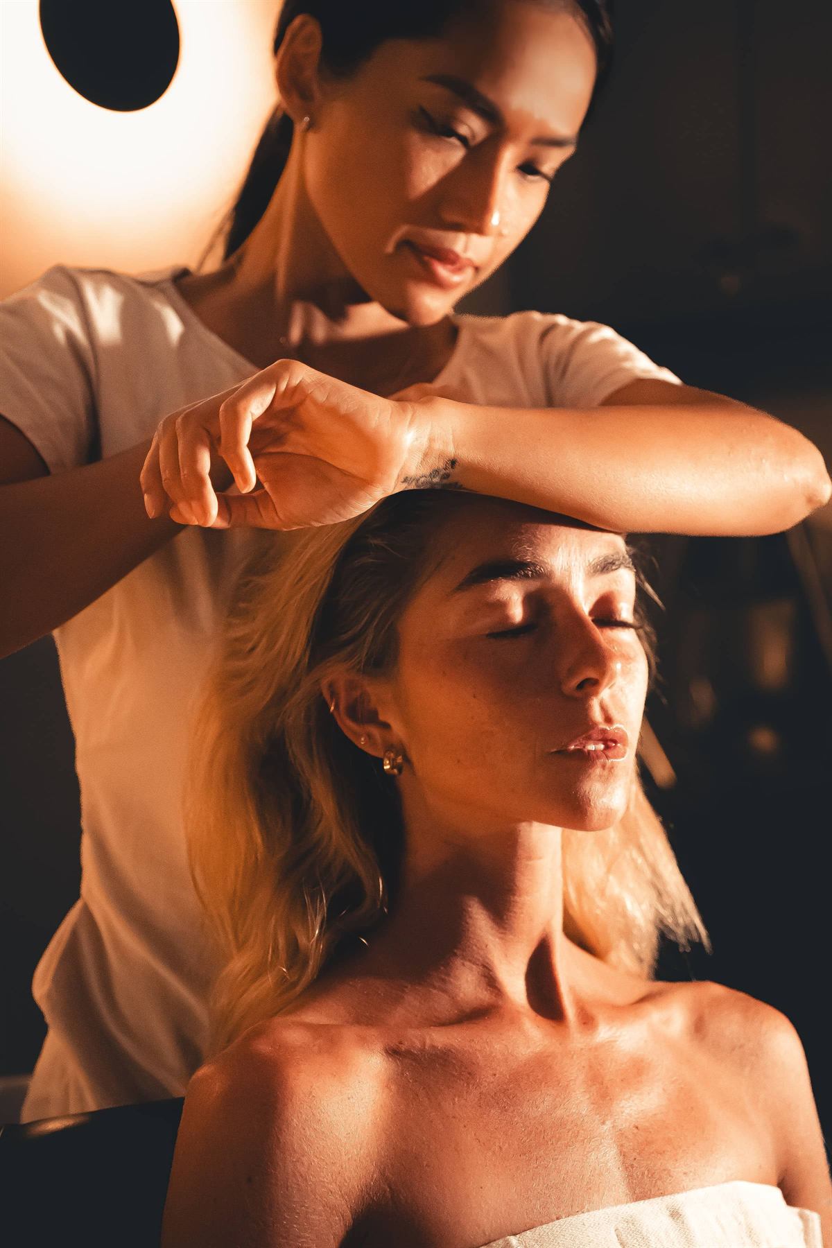 A guest deeply relaxed during a La Vela head spa treatment